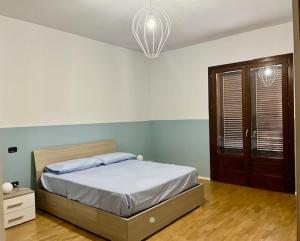 a bedroom with a bed and a chandelier at Casa Cerasoli Gallipoli in Gallipoli