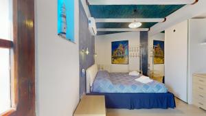 a bedroom with a blue bed in a room at Antico Centro Quartu in Quartu SantʼElena