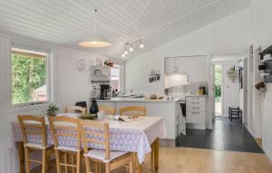 a kitchen and dining room with a table and chairs at 3 Bedroom Amazing Home In Aabybro in Åbybro