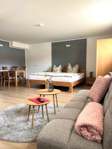 a living room with a couch and a bed at Pader-Motel in Paderborn