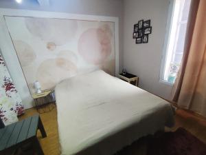 a bedroom with a white bed and two windows at Reve azur plage en duplex coeur de village in Le Pradet