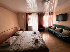 a bedroom with a large bed and a couch at Old Town - Andrew descent in Kyiv