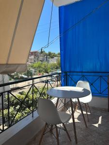 a table and two chairs on a balcony with a view at Almer room 2 in Himare