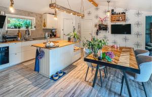 a kitchen with a wooden table and a dining room at 3 Bedroom Stunning Home In Strömstad in Strömstad