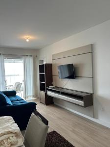 Μια τηλεόραση ή/και κέντρο ψυχαγωγίας στο Apartamento proximo ao mar