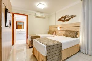 Cama ou camas em um quarto em BH Jaraguá Hotel