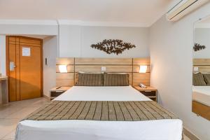 Cama ou camas em um quarto em BH Jaraguá Hotel