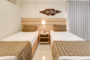 Cama ou camas em um quarto em BH Jaraguá Hotel