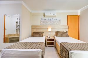 Cama ou camas em um quarto em BH Jaraguá Hotel