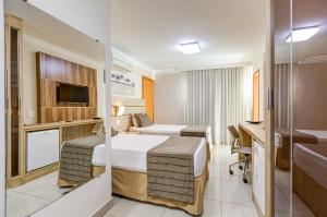 Cama ou camas em um quarto em BH Jaraguá Hotel