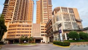 a group of tall buildings in a city at Galini Suites in Manila