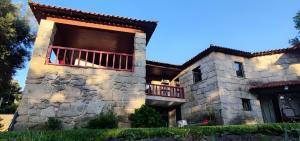 a large stone building with a balcony on it at Casa Nova das Oliveiras in Braga
