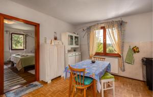 a kitchen with a table and a room with a bed at Gorgeous Home In Ravna Gora With Wifi in Ravna Gora