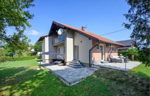 a house with a patio and a yard at 2 Bedroom Cozy Home In Duga Resa in Duga Resa