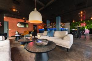 a living room with couches and tables and a bar at Centrum Hotel in Akureyri