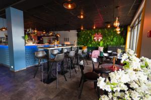 a bar in a restaurant with stools at Centrum Hotel in Akureyri