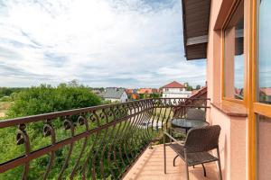a balcony with two chairs and a table at Villa Morska, 350 m do plaży in Ustronie Morskie