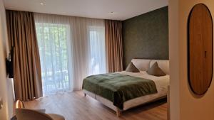 Ένα ή περισσότερα κρεβάτια σε δωμάτιο στο Jaukus poilsis Birštone