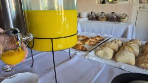 a table with a glass of orange juice and bread at Porto Monte in Maceira