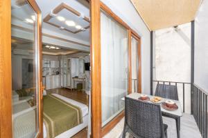 a balcony with a bed and a table and chairs at TAKSİM HAVANA HOTEL SUİTES in Istanbul