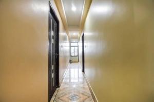 a hallway with two doors and a hallway with a ceiling at Hotel Galaxy in Kalyani