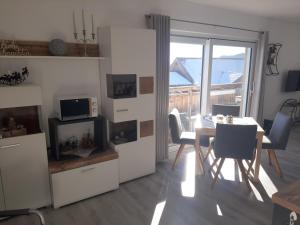 a kitchen and dining room with a table and chairs at Bergliebe - Panoramablick in Saurachberg