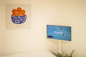 a flat screen tv hanging on a wall at Daechi Stay#Gangnam#COEX#Concert KSPO#강남세브란스병원#대치동학원가 in Seoul