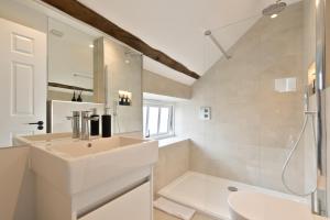 a white bathroom with a sink and a shower at Apartment 3 in York