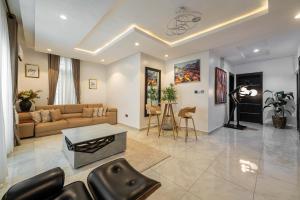 a living room with a couch and a table at Topaz Ologolo, Lekki in Lekki