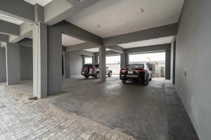 a garage with two cars parked in it at Topaz Ologolo, Lekki in Lekki