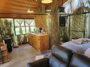 a bedroom with a large bed and a sink in it at Fisheagle Hut in Orania in Orania