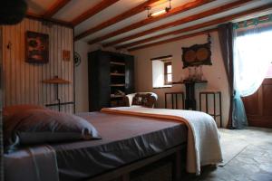 a bedroom with a bed in a room at Les Faes du Bos in Saint-Beauzire
