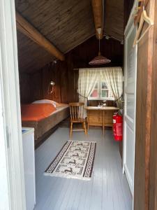 a bedroom with a bed and a desk and a table at Bygland Fjordhytter in Bygland