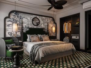 a bedroom with a large bed and a ceiling fan at L'Heritage Riverside Hoi An in Hoi An +91 photos