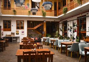 a restaurant with tables and chairs in a building at Nodo Cusco Garcilaso in Cusco