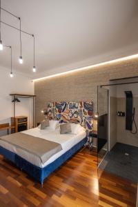 a bedroom with a large bed and a television at Noto Boutique Hotel in Noto