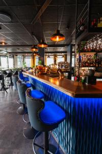 a bar with blue bar stools in a restaurant at Centrum Hotel in Akureyri