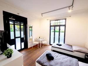 a room with two beds and a table in it at Monteurwohnung-in-Villa-8-Betten-WLAN-TV-Einbaukueche-Ahrensburg-Zentrum-Naehe-Hamburg-OD06a in Ahrensburg