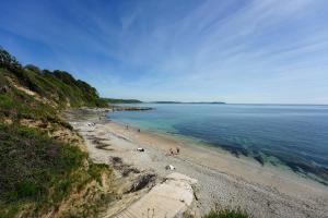 a group of people on a beach near the water at Hotel Meudon in Falmouth