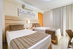 Cama ou camas em um quarto em BH Jaraguá Hotel mais 32 fotos