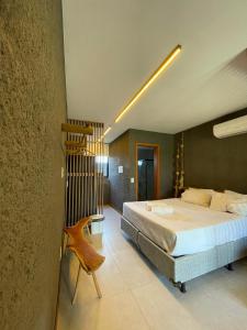 a bedroom with a large bed and a staircase at Vilas Manatee - Praia do Patacho in Pôrto de Pedras +30 photos