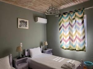 a bedroom with a bed and a painting on the wall at Christina Apartment in Mesochórion