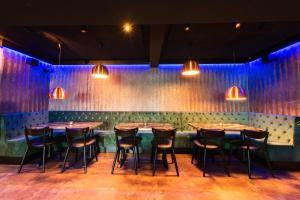 a row of tables and chairs in a room with lights at Centrum Hotel in Akureyri