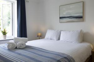 a bedroom with a bed with towels on it at Bridge View in Oxford
