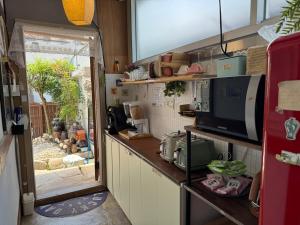 a kitchen with a counter with a microwave at Pungnam House in Jeonju