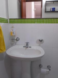 a bathroom with a white sink and a mirror at Tu Estancia en Cali - Valle del Lili in Cali