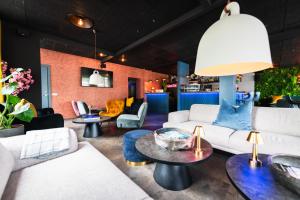 a living room with couches and tables at Centrum Hotel in Akureyri