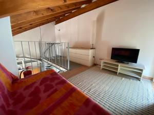 a living room with a bed and a flat screen tv at Navigli Downtown Cocco House in Milan +71 photos