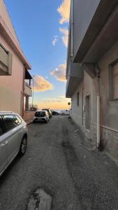 a parking lot with cars parked next to a building at Brezza Marina in Gallico +2 photos