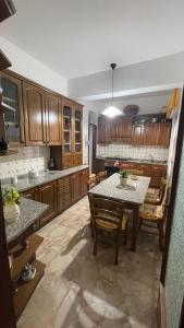 a kitchen with a table and chairs in a room at Brezza Marina in Gallico